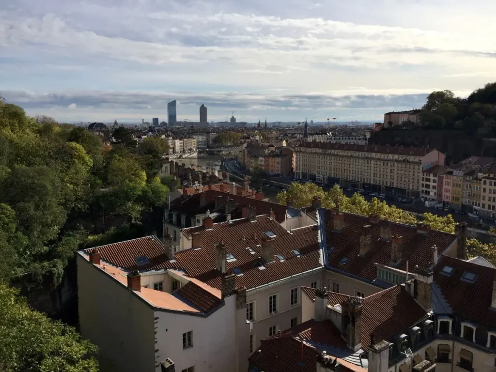 Panoramic view over Lyon's rooftops and the Saone river from Parc des Chartreux, with the Part-Dieu skyline in the background