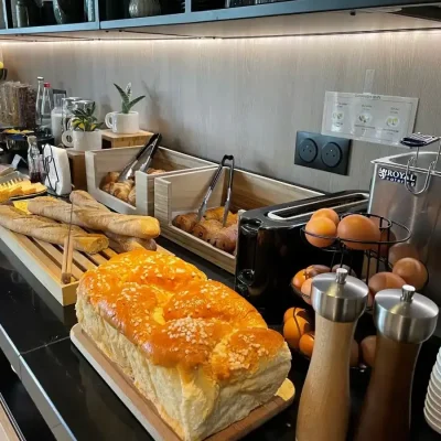 Breakfast buffet with bread, pastries and eggs at Hôtel Villa Berlioz Lyon