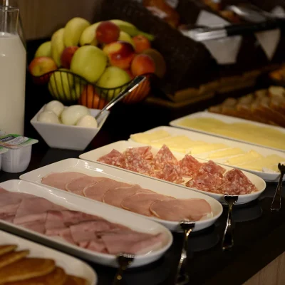 Savory breakfast buffet with cold cuts, cheeses, eggs and fruits at Hôtel Villa Berlioz Lyon