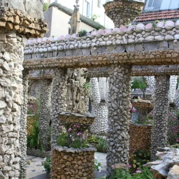 Stone and shell-encrusted columns and pergola in the Rosa Mir garden, a unique outsider art garden in Lyon's Croix-Rousse district