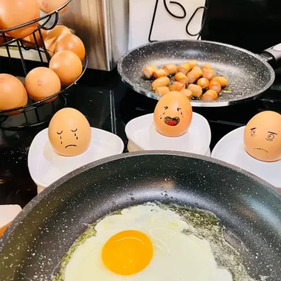 Eggs and sausages being prepared for breakfast at Hôtel Villa Berlioz Lyon